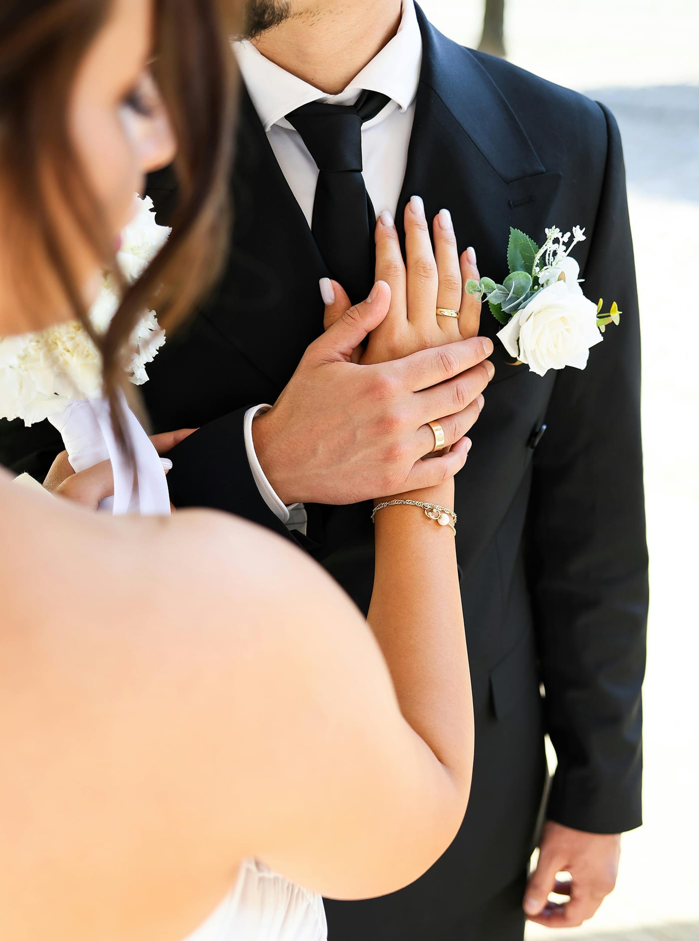 Bride with hand on grooms chest